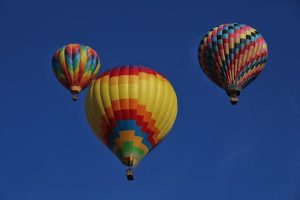 Multicoloured aerial balloons floating in a blue sky