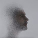 Fuzzy profile of young man's face on grey background